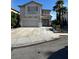 Charming two-story home boasts a large garage, desert landscaping, and a red-tile roof under a bright blue sky at 9641 Windborne Ave, Las Vegas, NV 89147