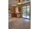 Kitchen with wood cabinets, a ceiling fan with light, and sliding glass doors to the backyard at 9641 Windborne Ave, Las Vegas, NV 89147