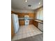 Bright kitchen features light-colored cabinetry, white appliances, and tile flooring at 9641 Windborne Ave, Las Vegas, NV 89147