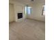 Living area includes a fireplace, carpet, and large windows that let in natural light at 9641 Windborne Ave, Las Vegas, NV 89147