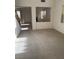 Bright, carpeted living room boasts an open floor plan and views into the next room at 9641 Windborne Ave, Las Vegas, NV 89147