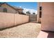 Backyard featuring rock landscaping, privacy walls, and view of neighboring houses at 9704 Falling Star Ave, Las Vegas, NV 89117