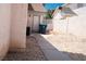 Side yard featuring rock landscaping, privacy wall, and utility access at 9704 Falling Star Ave, Las Vegas, NV 89117
