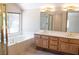 Bright bathroom featuring a soaking tub under a window, a shower, and a double sink vanity at 9704 Falling Star Ave, Las Vegas, NV 89117
