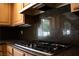 Clean kitchen boasting granite countertops, wood cabinets, and modern appliances at 9704 Falling Star Ave, Las Vegas, NV 89117