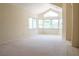 Large living room featuring high ceilings, carpeted floors and large windows at 9704 Falling Star Ave, Las Vegas, NV 89117