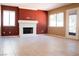 Bright living room offering a white brick fireplace, tile floors, two windows, and a glass patio door at 9704 Falling Star Ave, Las Vegas, NV 89117