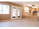 Spacious living area with tile flooring, decorative glass doors, and an open view into the kitchen at 9704 Falling Star Ave, Las Vegas, NV 89117