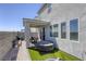 Exterior of home with covered patio, artificial turf, built in hot tub and bbq area at 9772 Alpine Style Dr, Las Vegas, NV 89166