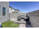 Cozy backyard featuring a fire pit, seating area, artificial grass, and rock landscaping, perfect for outdoor entertaining at 9772 Alpine Style Dr, Las Vegas, NV 89166