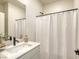 Clean, well-lit bathroom with modern fixtures, vanity, and shower with curtain at 9772 Alpine Style Dr, Las Vegas, NV 89166