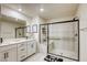Updated bathroom featuring sleek glass shower with seating, modern fixtures and ample counter space at 9772 Alpine Style Dr, Las Vegas, NV 89166