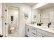 Bright bathroom featuring dual sinks, quartz counters, and modern matte black hardware and fixtures at 9772 Alpine Style Dr, Las Vegas, NV 89166