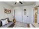 Comfortable bedroom with a gray sofa, neutral rug, and ceiling fan at 9772 Alpine Style Dr, Las Vegas, NV 89166