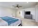 Bedroom featuring soft carpet, fan, and natural light with a bonus room or office area at 9772 Alpine Style Dr, Las Vegas, NV 89166
