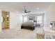 Spacious bedroom boasts plush carpeting, large windows, and a decorative ceiling fan at 9772 Alpine Style Dr, Las Vegas, NV 89166