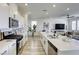 Bright open-concept kitchen with stainless steel appliances and large island that overlooks living area at 9772 Alpine Style Dr, Las Vegas, NV 89166