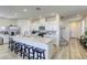 Modern kitchen with a large white island, stainless steel appliances, and sleek cabinetry at 9772 Alpine Style Dr, Las Vegas, NV 89166