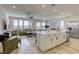 Bright, open kitchen featuring a spacious island, modern finishes, and seamless flow to living room at 9772 Alpine Style Dr, Las Vegas, NV 89166