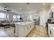 Open-concept kitchen with a large island, modern appliances, and connection to the living area at 9772 Alpine Style Dr, Las Vegas, NV 89166