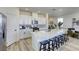 Modern kitchen features white cabinets, stainless appliances, quartz counters, and large island with seating at 9772 Alpine Style Dr, Las Vegas, NV 89166