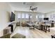 Open living room with large windows for natural light, ceiling fan, and neutral decor at 9772 Alpine Style Dr, Las Vegas, NV 89166