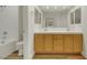 Bathroom with double sinks, wood-look flooring, and white subway tile at 9962 Catalina Canyon Ave, Las Vegas, NV 89147