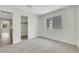 A cozy bedroom featuring a carpeted floor, closet, and large window at 9962 Catalina Canyon Ave, Las Vegas, NV 89147