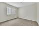 Comfortable bedroom with neutral carpet, a large window for natural light, and a clean, minimalist design at 9962 Catalina Canyon Ave, Las Vegas, NV 89147