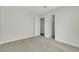 Bedroom with neutral carpet, closet access, and two white doors leading to other areas of the home at 9962 Catalina Canyon Ave, Las Vegas, NV 89147