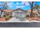 Single-story home featuring a two-car garage, desert landscaping, and a classic facade at 9962 Catalina Canyon Ave, Las Vegas, NV 89147