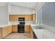 A well-lit kitchen with modern appliances, light wood cabinetry, and a large window at 9962 Catalina Canyon Ave, Las Vegas, NV 89147