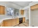Bright kitchen featuring light wood cabinetry, a stainless steel sink, and a view of the outdoors at 9962 Catalina Canyon Ave, Las Vegas, NV 89147