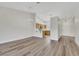 Open-concept living space with light wood floors, modern lighting, and a seamless flow to the kitchen at 9962 Catalina Canyon Ave, Las Vegas, NV 89147