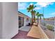 A view of the side yard featuring a sliding glass door, rock cover, and exterior of the house at 9962 Catalina Canyon Ave, Las Vegas, NV 89147
