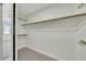 Walk-in closet with custom shelving and plush carpet at 9962 Catalina Canyon Ave, Las Vegas, NV 89147