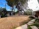 Spacious backyard featuring mature trees, storage shed, and patio area, providing a private outdoor space at 1020 Wengert Ave, Las Vegas, NV 89104