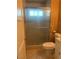 Bathroom featuring a toilet and a shower with patterned glass doors at 1020 Wengert Ave, Las Vegas, NV 89104