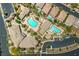An aerial view shows the community pool, landscaping, and parking at this beautiful HOA in Summerlin West at 10425 White Princess Ave, Las Vegas, NV 89166