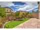 Well-maintained backyard featuring desert landscaping, artificial turf, and brick pavers at 10425 White Princess Ave, Las Vegas, NV 89166