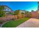 Beautifully landscaped backyard with a lush lawn and a brick-paved walkway at 10425 White Princess Ave, Las Vegas, NV 89166