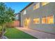 Exterior backyard view with brick patio, artificial turf and desert landscaping at 10425 White Princess Ave, Las Vegas, NV 89166