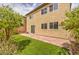 Backyard featuring a brick patio, desert landscaping, and artificial turf at 10425 White Princess Ave, Las Vegas, NV 89166