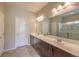 Bathroom featuring double sinks, dark wood cabinets, and a glass door shower at 10425 White Princess Ave, Las Vegas, NV 89166
