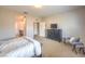 Neutral bedroom featuring a black dresser and a decorative sitting bench at 10425 White Princess Ave, Las Vegas, NV 89166