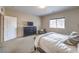 Cozy bedroom with natural light, carpeted floors, and a view towards the entryway at 10425 White Princess Ave, Las Vegas, NV 89166