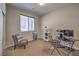 Cozy bedroom with neutral walls, carpet, and a comfortable chair at 10425 White Princess Ave, Las Vegas, NV 89166