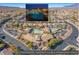Aerial view of community pool with surrounding homes and desert mountains at 10425 White Princess Ave, Las Vegas, NV 89166
