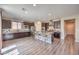 Open kitchen with dark wood cabinets, stainless steel appliances, and center island at 10425 White Princess Ave, Las Vegas, NV 89166