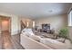 Spacious living room with fireplace, wood-look flooring, and comfortable seating at 10425 White Princess Ave, Las Vegas, NV 89166